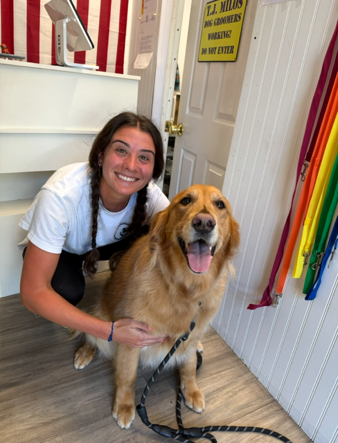 Julie Conforti with a dog at The Groom Room Pet Salon